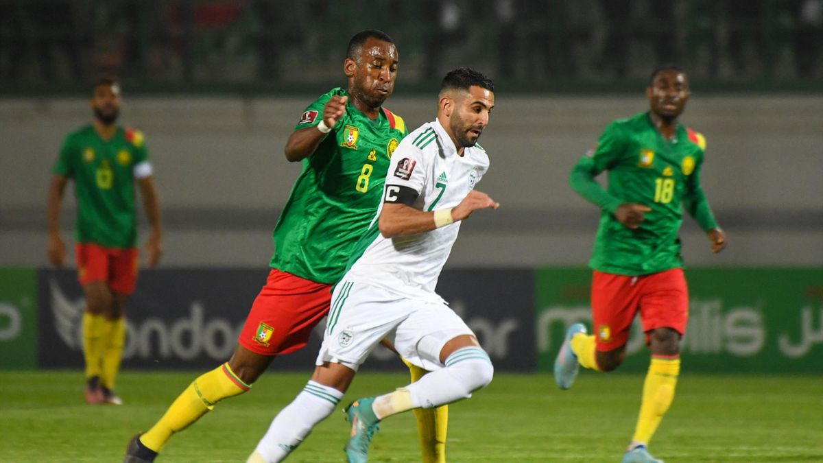 Algeria's forward Riyad Mahrez vies for the ball with Cameroon's midfielder Gael Ondoua (L) during the second leg of the 2022 Qatar World Cup African Qualifiers football match between Algeria and Cameroon at the Mustapha Tchaker Stadium in the city of Bli