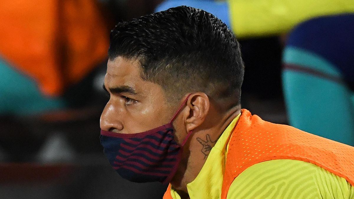 Luis Suarez of FC Barcelona wearing a protection face mask looks on during the Liga match between RCD Mallorca and FC Barcelona at Estadio de Son Moix on June 13, 2020 in Mallorca, Spain