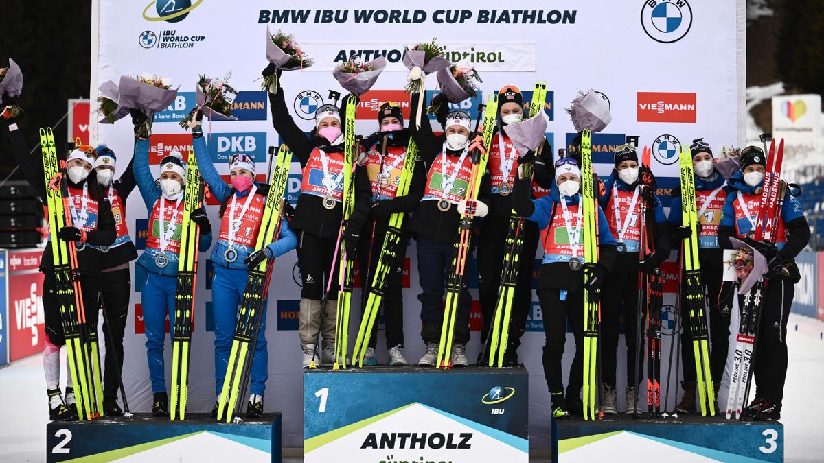 The teams of Russia, Norway and France pose on the podium after the IBU Biathlon World Cup Women 4X6km Relay Competition in Antholz-Anterselva, Italian Alps, on January 22, 2022.