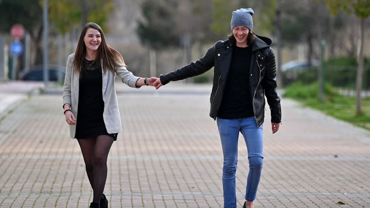 France and Atletico Madrid women's team goalkeeper Pauline Peyraud-Magnin (L) and her partner Camille Nell walk during an interview with AFP in Madrid on February 27, 2021.
