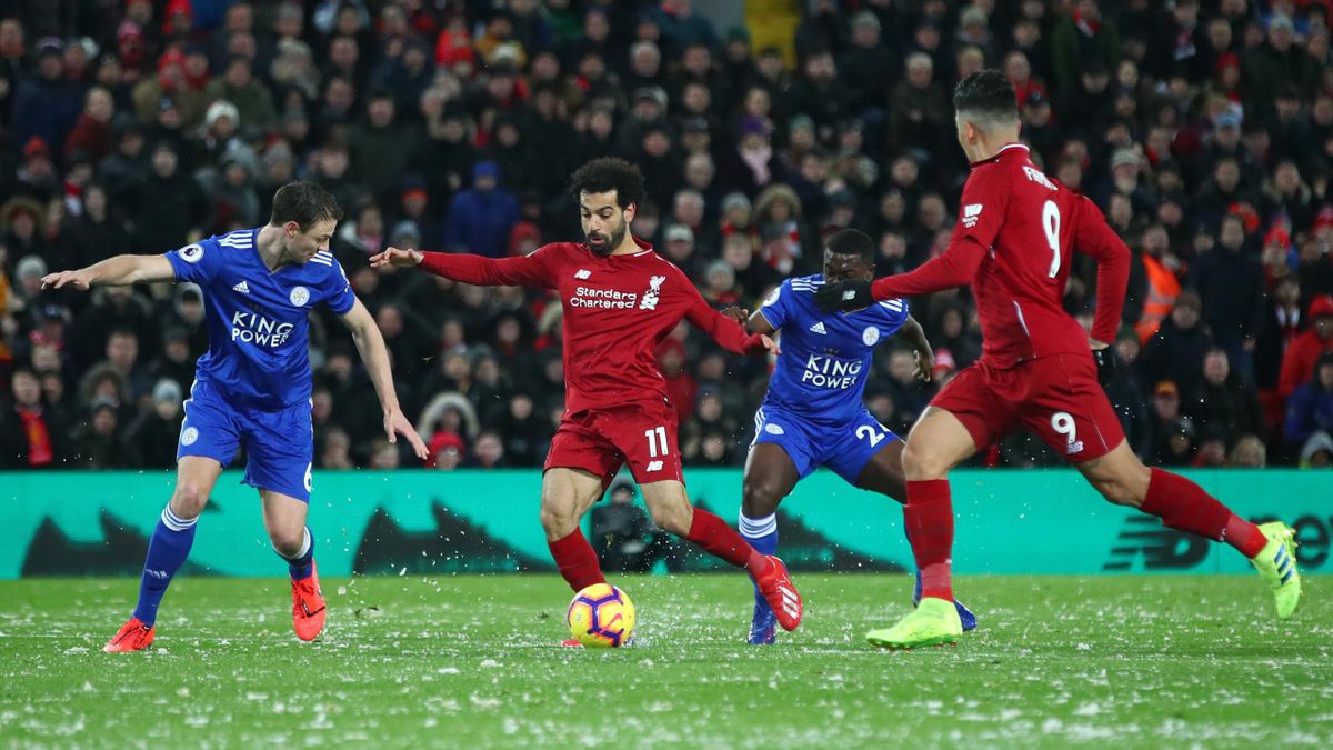 Mohamed Salah of Liverpool takes on Jonny Evans and Nampalys Mendy of Leicester City during the Premier League match between Liverpool FC and Leicester City at Anfield on January 30, 2019 in Liverpool, United Kingdom
