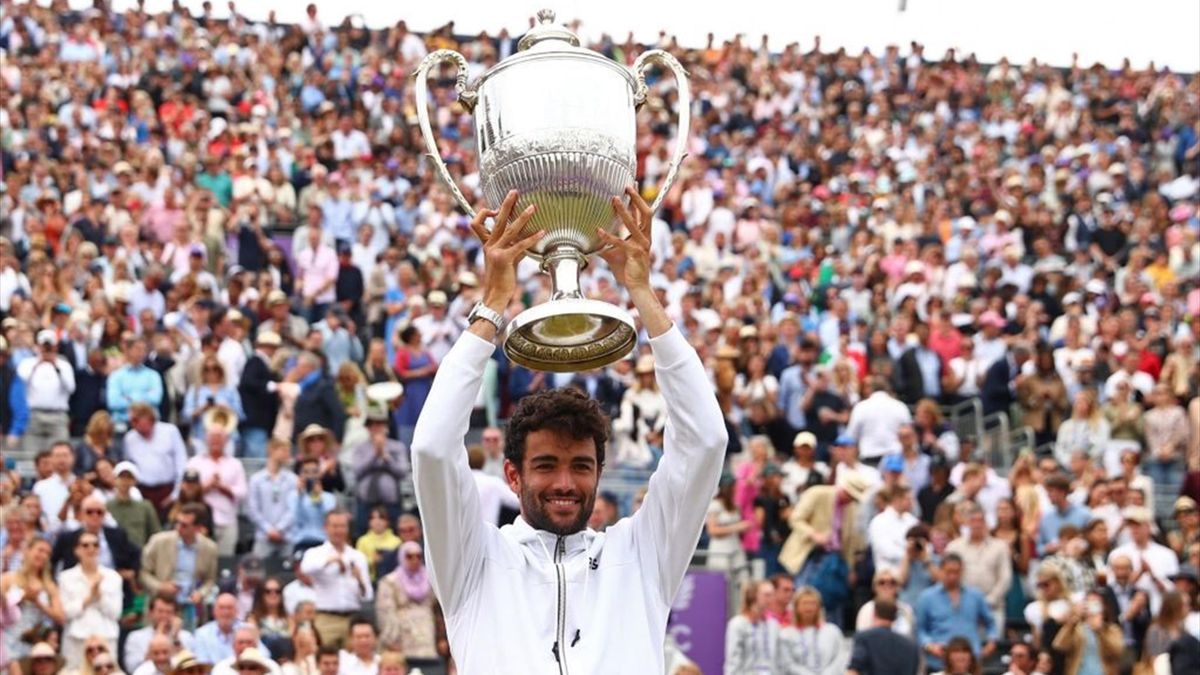 Italy's Matteo Berrettini poses for a photograph as he celebrates with the trophy after his win in his men's singles final tennis match against Serbia's Filip Krajinovic on Day 7 of the cinch ATP Championships at Queen's Club in west London, on June 19, 2