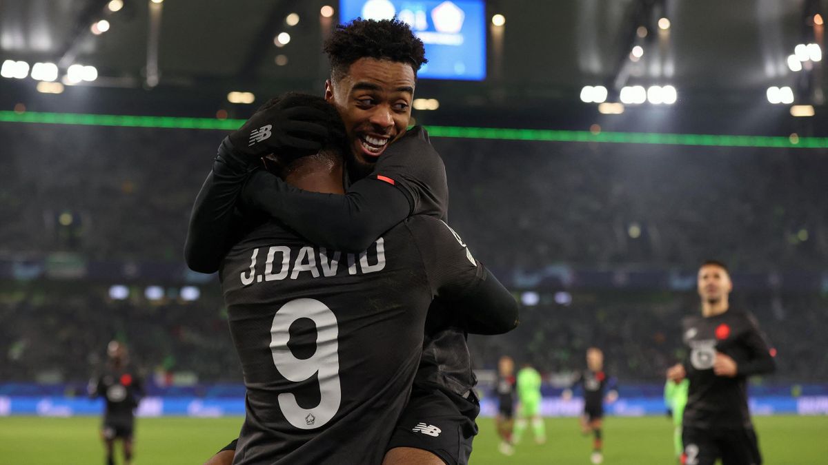 Lille's Canadian forward Jonathan David (front) celebrates scoring with his team-mate Lille's English midfielder Angel Gomes