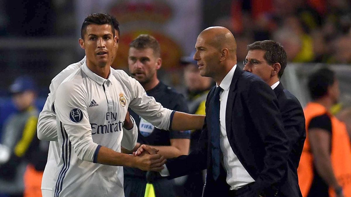 Real Madrid's Portuguese forward Cristiano Ronaldo (L) celebrates after his goal with Real Madrid's French coach Zinedine Zidane during the UEFA Champions League first leg football match between Borussia Dortmund and Real Madrid at BVB stadium in Dortmund