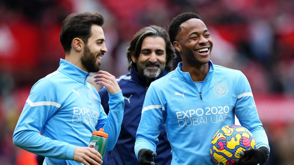 Bernardo Silva and Raheem Sterling of Manchester City react during the warm up prior to the Premier League match between Manchester United and Manchester City