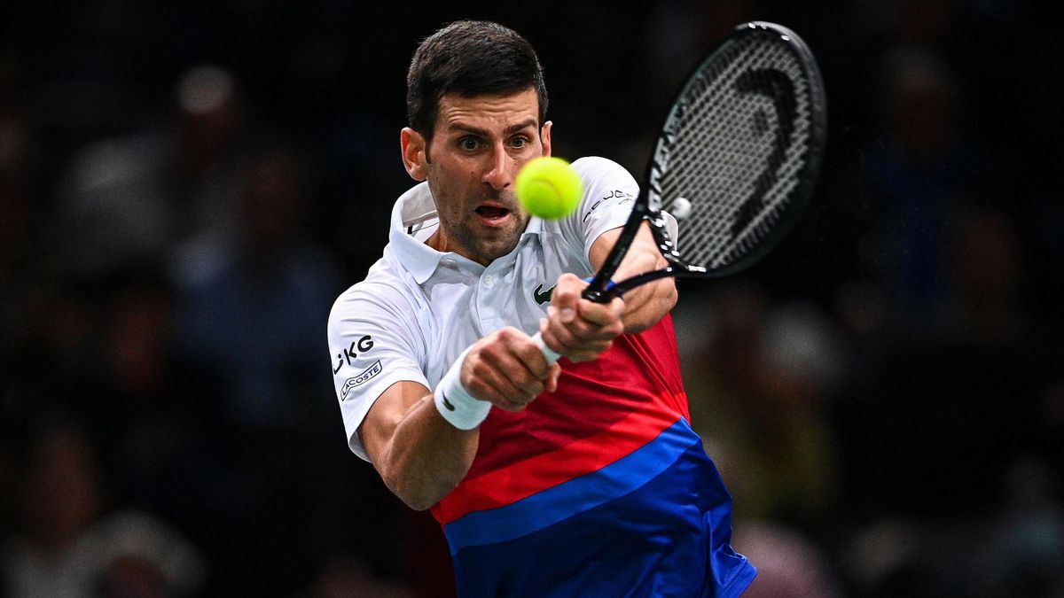 Serbia's Novak Djokovic returns the ball to Poland's Hubert Hurkacz during their their men's singles semi-final tennis match on day five of the ATP Paris Masters at The AccorHotels Arena in Paris on November 6, 2021. (Photo by Christophe ARCHAMBAULT / AFP