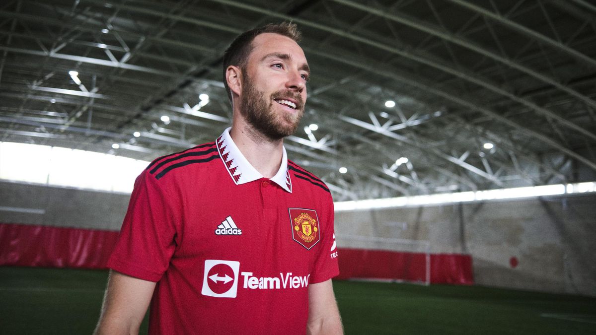 Christian Eriksen of Manchester United poses after signing for the club at Carrington Training Ground on July 26, 2022 in Manchester, England.