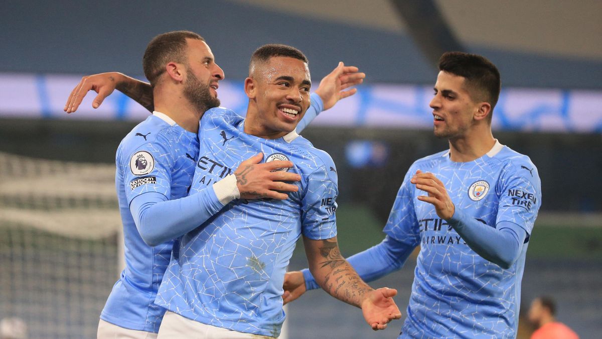 Gabriel Jesus of Manchester City celebrates with team mates Joao Cancelo and Kyle Walker after scoring their side's second goal during the Premier League match between Manchester City and Wolverhampton Wanderers at Etihad Stadium on March 02, 2021 in Man