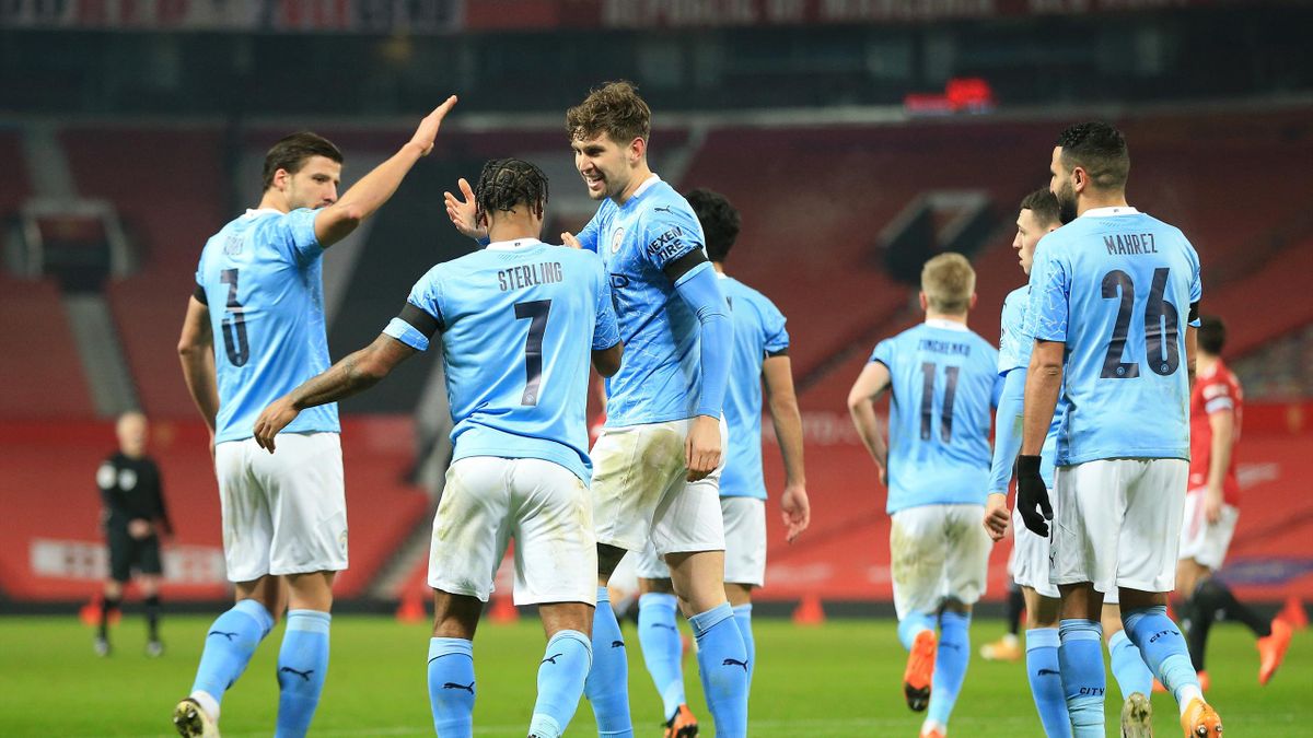 John Stones of Manchester City celebrates with Ruben Dias and Raheem Sterling after scoring his sides 1st goal during the Carabao Cup Semi Final match between Manchester United and Manchester City at Old Trafford on January 06, 2021