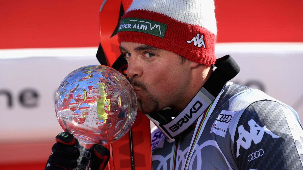 Peter Fill of Italy celebrates with the season-ending globe after winning the overall World Cup Men's Downhill title