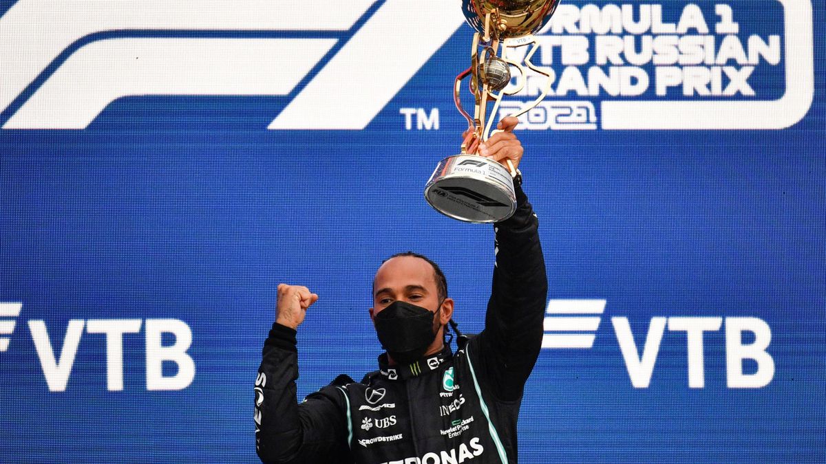 Mercedes' British driver Lewis Hamilton celebrates on the podium after the Formula One Russian Grand Prix at the Sochi Autodrom circuit in Sochi on September 26, 2021.