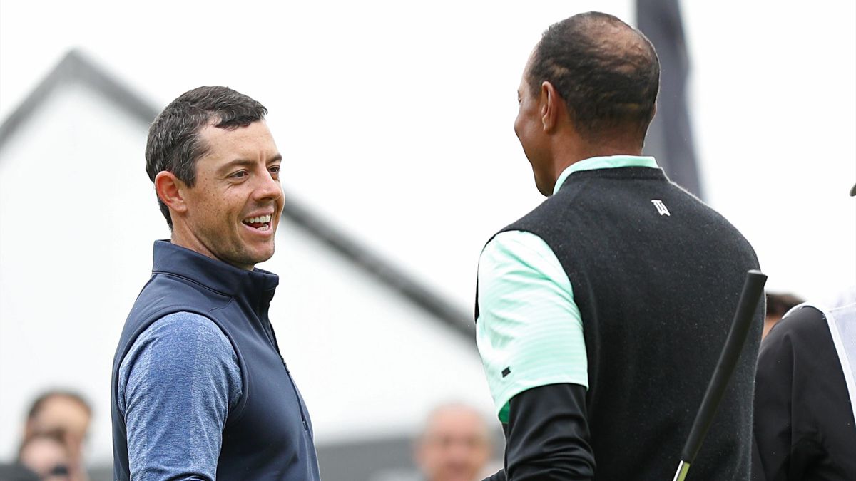 Rory McIlroy of Northern Ireland (L) and Tiger Woods shake hands