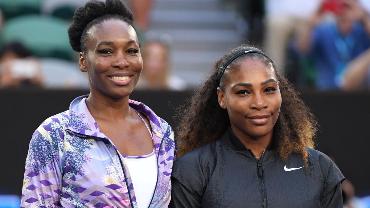 Serena Williams of the US (R) and Venus Williams of the US pose for photographs