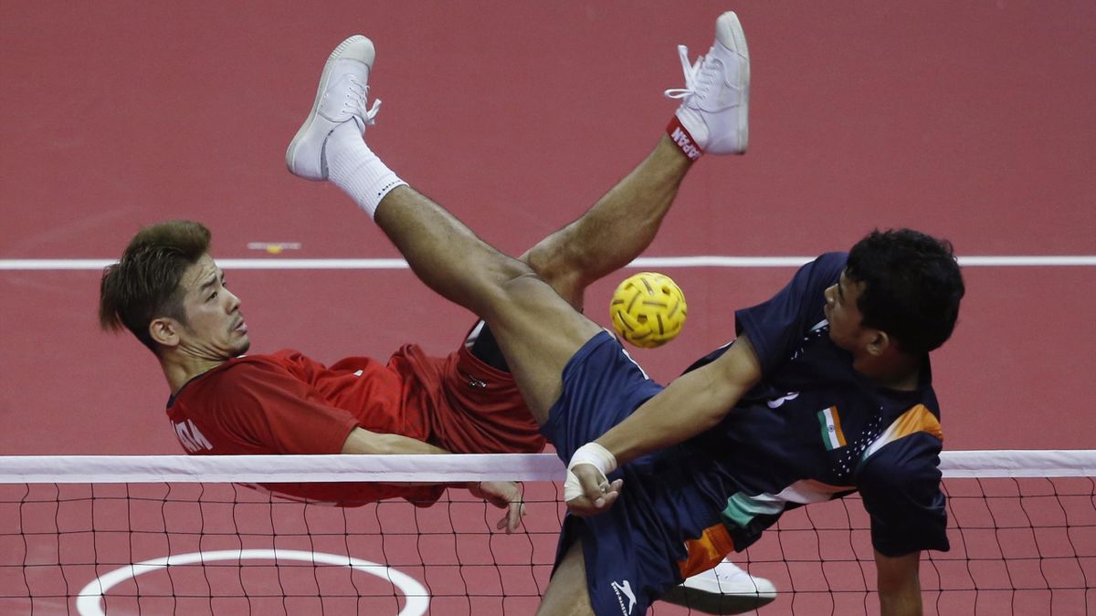 Japan's Takeshi Terashima (L) strikes the ball against India during their men's team sepaktakraw game at the Bucheon Gymnasium during the 17th Asian Games in Incheon (Reuters) 