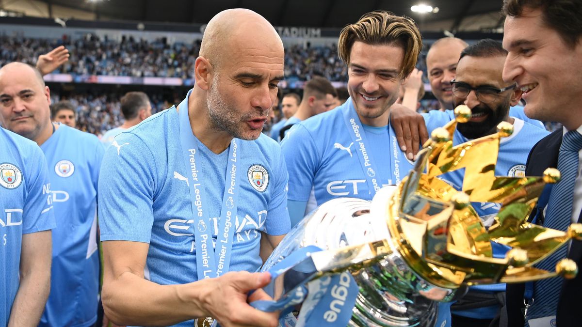 Pep Guardiola, Manager of Manchester City celebrates with the Premier League trophy