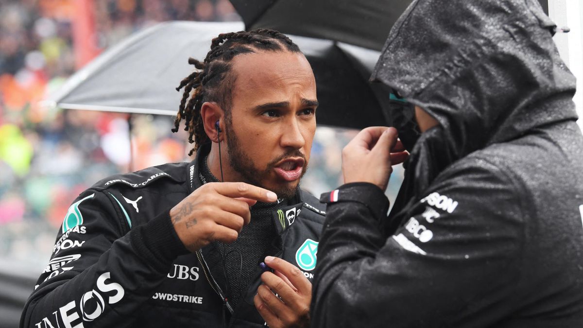 Mercedes' British driver Lewis Hamilton speaks with a staff member on the starting grid before the Formula One Belgian Grand Prix at the Spa-Francorchamps circuit in Spa on August 29, 2021.