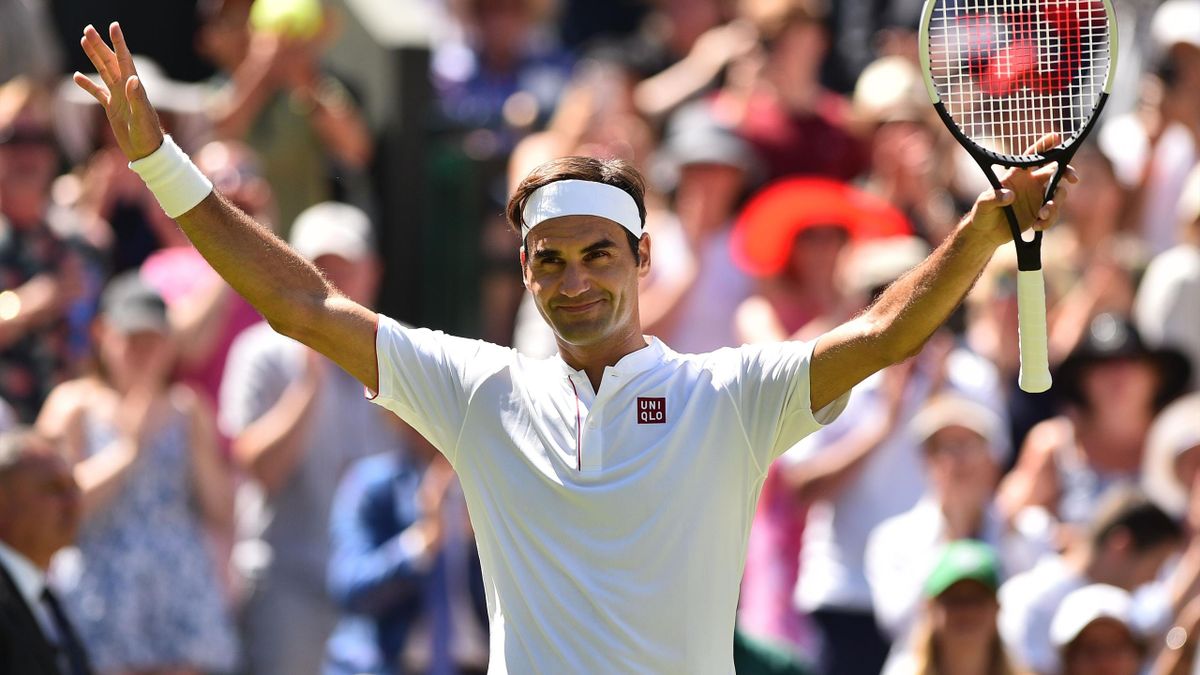Switzerland's Roger Federer celebrates after beating Serbia's Dusan Lajovic 6-1, 6-3, 6-4 in their men's singles first round match on the first day of the 2018 Wimbledon Championships