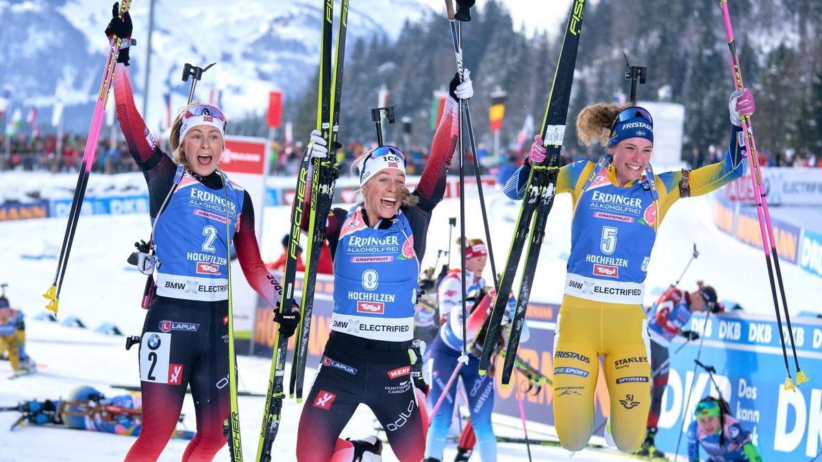 Third placed Norway's Ingrid Landmark Tandrevold, einner Norway's Tiril Eckhoff and Second placed Sweden's Hanna Oeberg celebrate after the IBU Biathlon World Cup women 10 km pursuit competition in Hochfilzen, Austria, on December 15, 2019