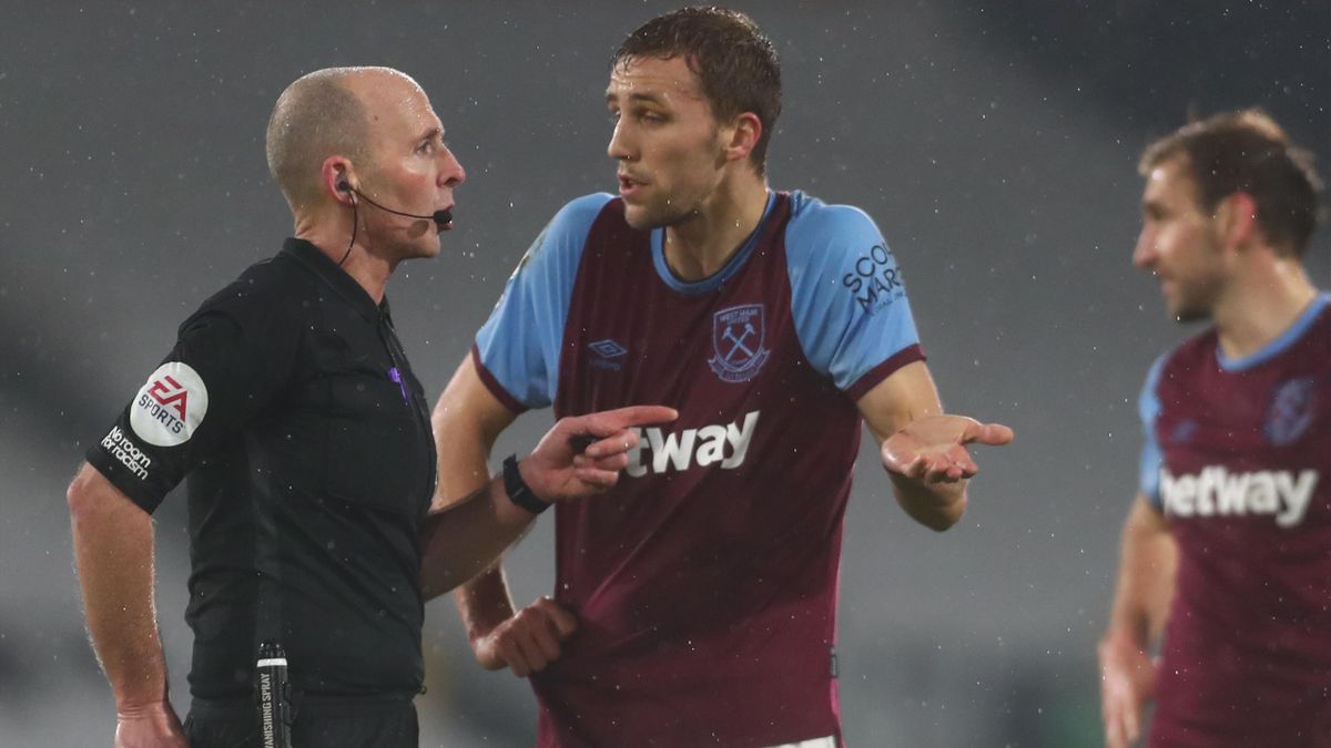 Referee Mike Dean (L) sends West Ham United's Czech midfielder Tomas Soucek (C) off during the English Premier League football match between Fulham and West Ham United at Craven Cottage in London on February 6, 2021.