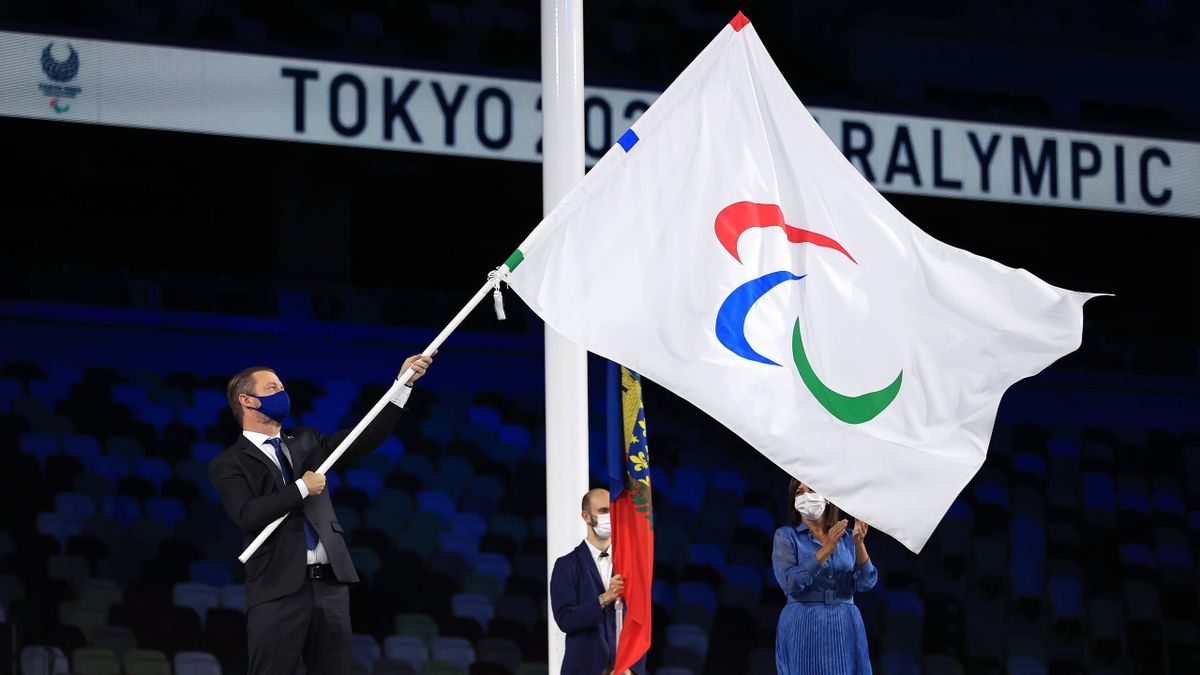 TOKYO, JAPAN - SEPTEMBER 05: Andrew Parsons, President of the International Paralympic Committee hands over the Paralympic flag to Anne Hidalgo, Mayor of Paris during the Flag Handover Ceremony during the Closing Ceremony on day 12 of the Tokyo 2020 Paral