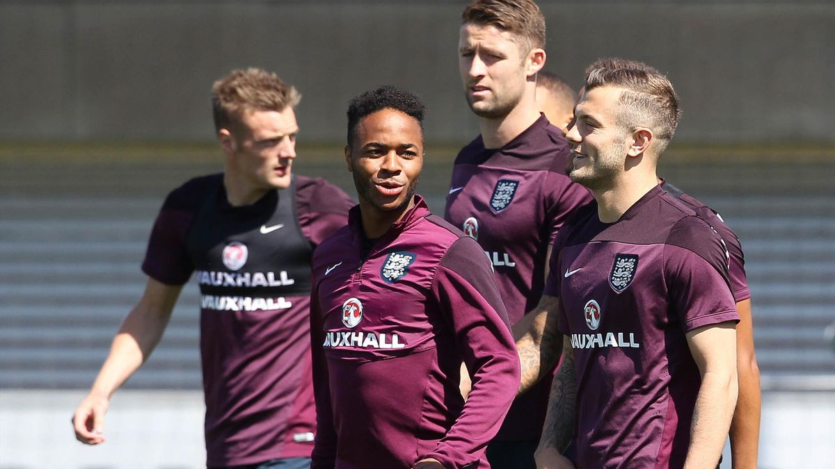England's Raheem Sterling (C) talks with team mate Jack Wilshere (R) during an England team training session at Saint George's Park