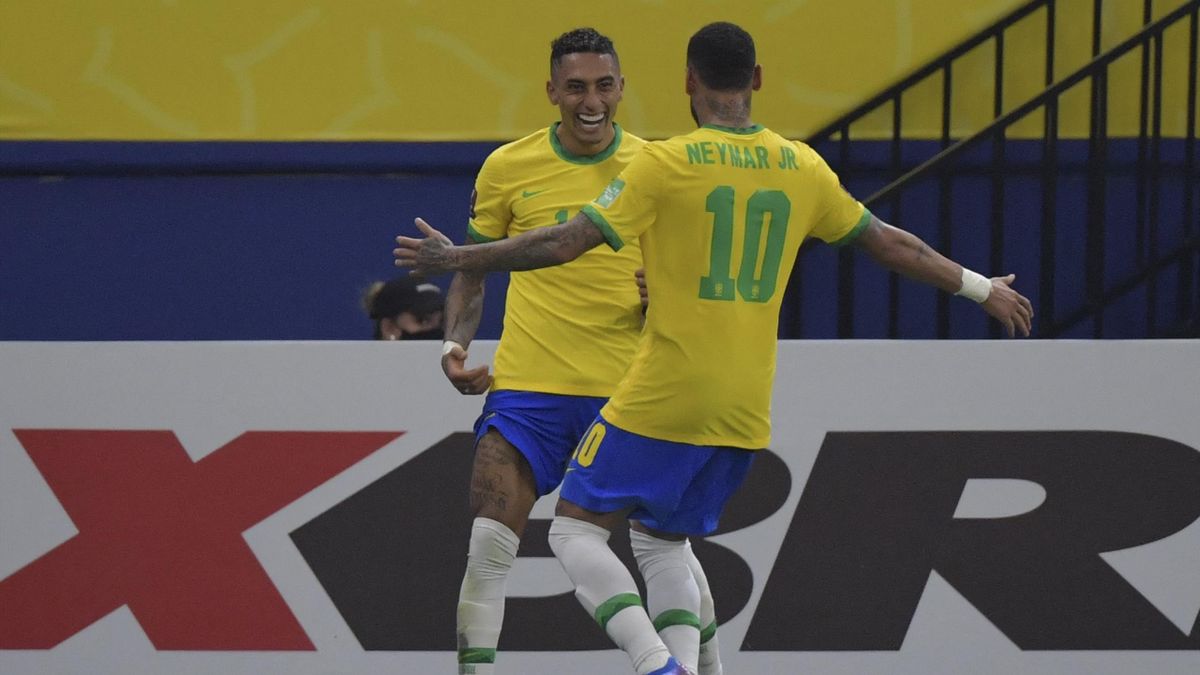 Brazil's Raphinha (L) celebrates with Neymar after scoring against Uruguay during the South American qualification football match for the FIFA World Cup Qatar 2022, in Arena Amazonia, Manaus, Brazil, on October 14, 2021