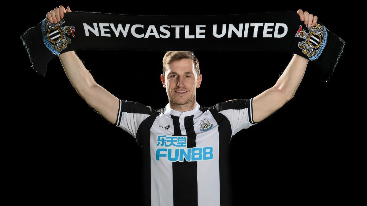 Chris Wood poses for photographs holding a Newcastle Scarf at the Newcastle United Training Centre on January 13, 2022 in Newcastle upon Tyne, England. (Photo by Serena Taylor/Newcastle United via Getty Images)