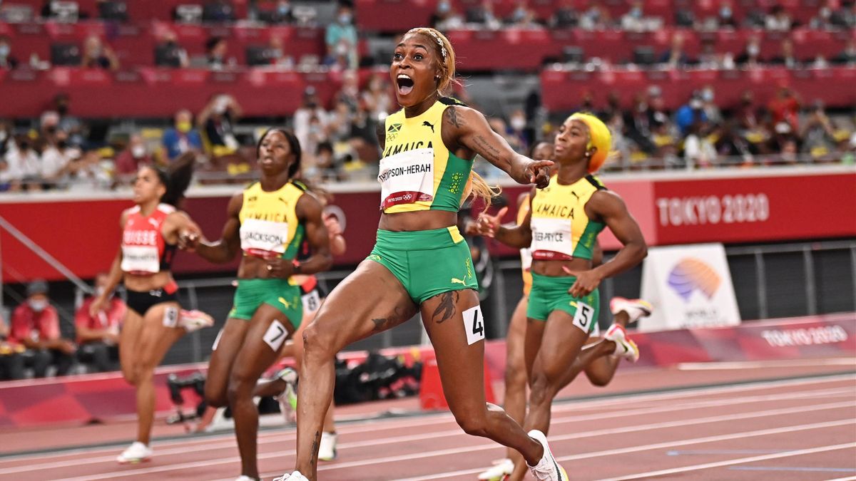 Jamaica's Elaine Thompson-Herah (C) crosses the finish line to win the women's 100m final next to third-placed Jamaica's Shericka Jackson (L) and second-placed Jamaica's Shelly-Ann Fraser-Pryce (R) during the Tokyo 2020 Olympic Games at the Olympic Stadiu