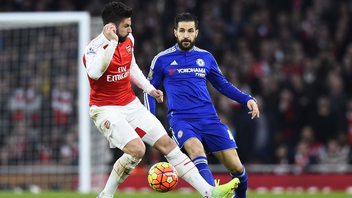 Arsenal's Olivier Giroud in action with Chelsea's Cesc Fabregas