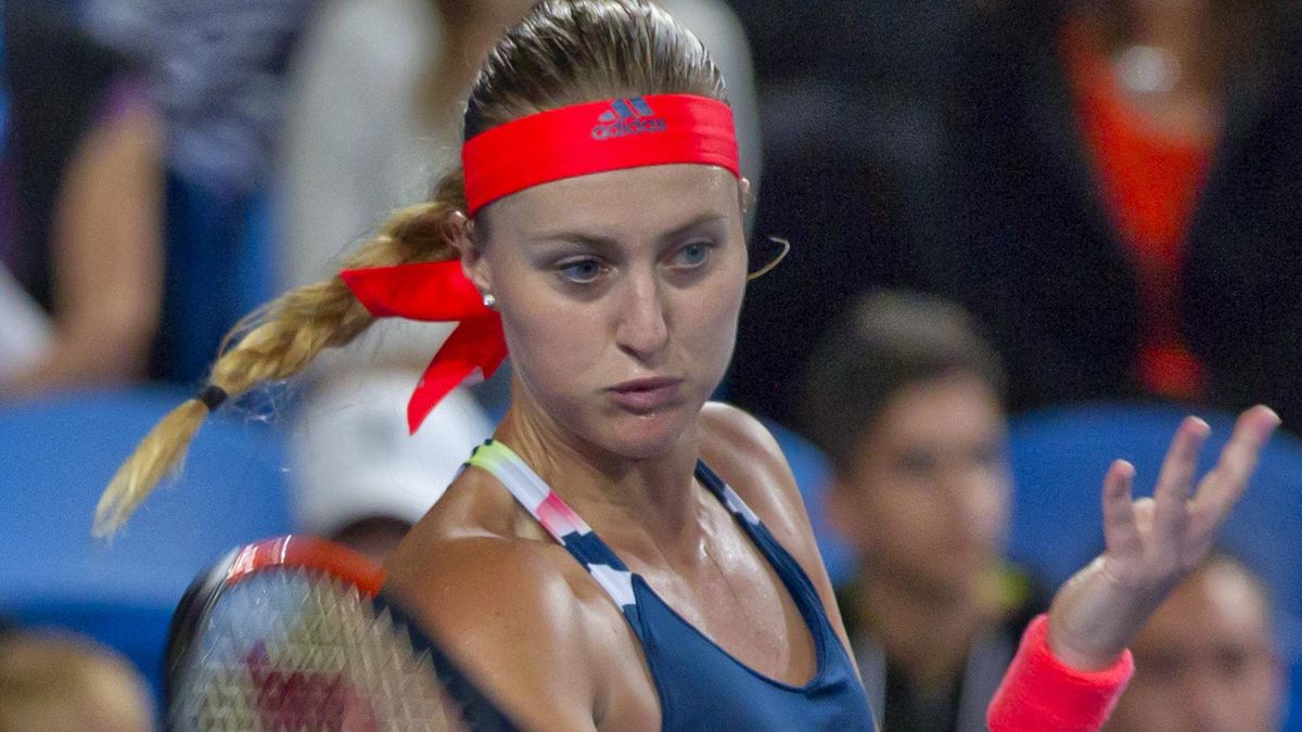 Kristina Mladenovic of France hits a return against Belinda Bencic of Switzerland in the Hopman Cup