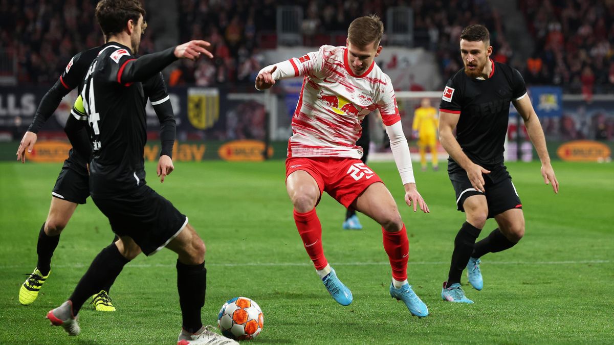 LEIPZIG, GERMANY - FEBRUARY 11: Dani Olmo of RB Leipzig battles for possession with Jonas Hector of 1.FC Koln during the Bundesliga match between RB Leipzig and 1. FC Köln at Red Bull Arena on February 11, 2022 in Leipzig, Germany. (Photo by Alexander Has