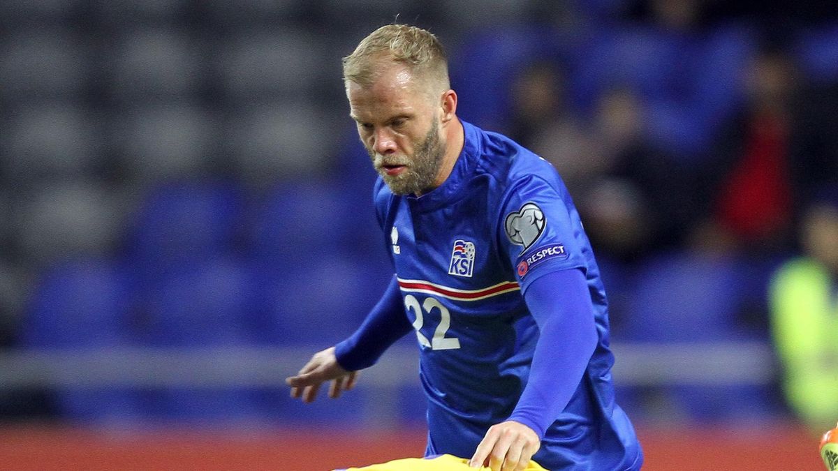 Kazakhstan's defender Gafurzhan Suyumbayev (bottom) vies for the ball with Iceland's forward Eidur Gudjohnsen during the Euro 2016 qualifying football match between Kazakhstan and Iceland in Astana on March 28, 2015.