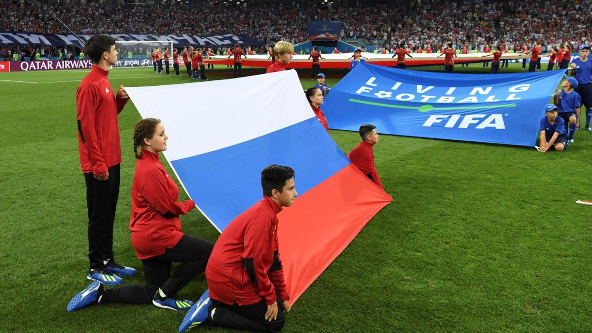 Volunteers hold the Russian flag before the Russia 2018 World Cup quarter-final football match between Russia and Croatia at the Fisht Stadium in Sochi on July 7, 2018.