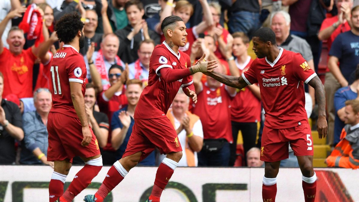 Liverpool's Brazilian midfielder Roberto Firmino (C) celebrates with teammates after scoring the opening goal