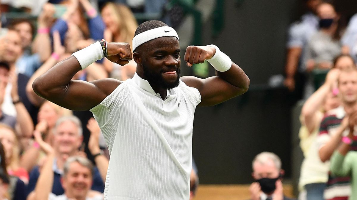 US player Frances Tiafoe celebrates his win over Greece's Stefanos Tsitsipas during their men's singles first round match on the first day of the 2021 Wimbledon Championships at The All England Tennis Club