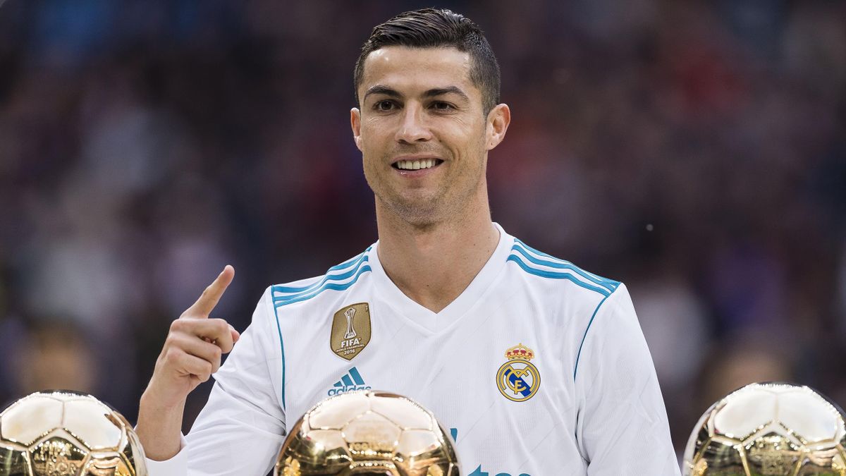 Cristiano Ronaldo of Real Madrid poses for photos with his FIFA Ballon Dor Trophies