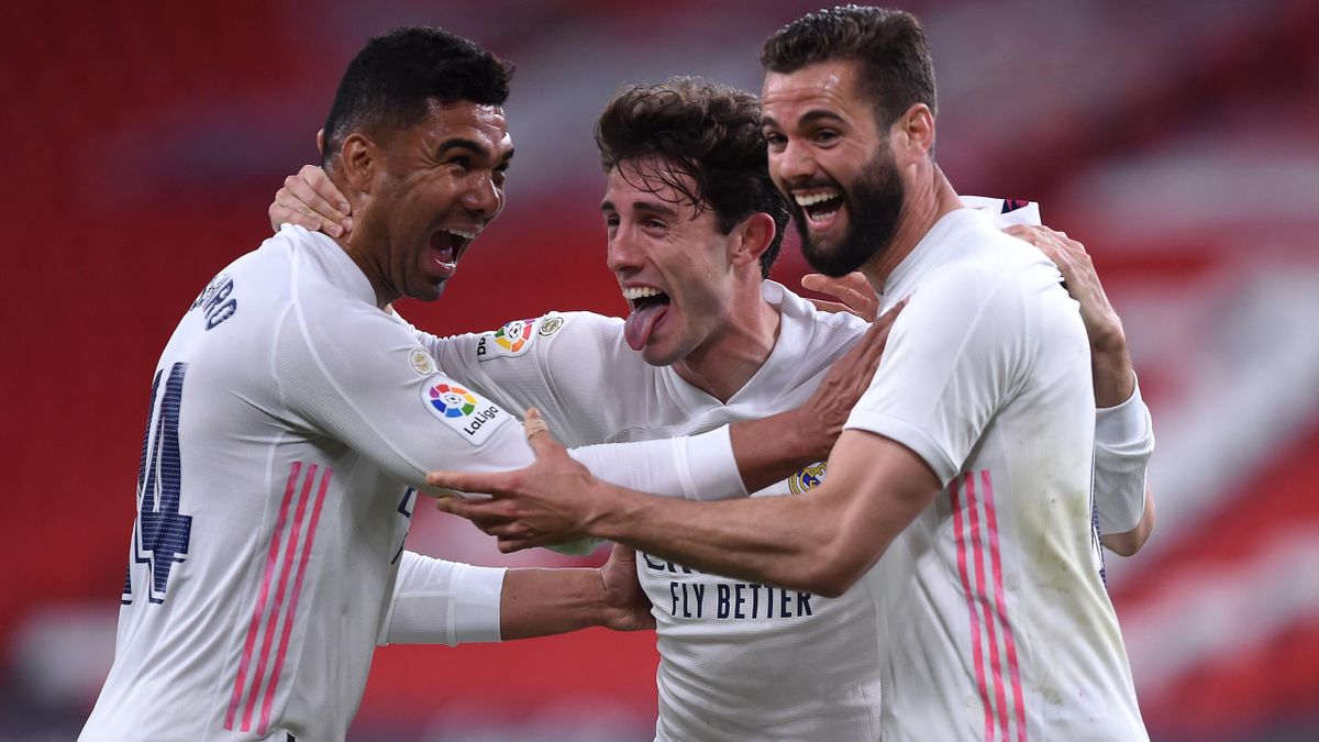 Nacho of Real Madrid celebrates with team mates (L - R) Casemiro and Alvaro Odriozola after scoring their side's first goal during the La Liga Santander match between Athletic Club and Real Madrid