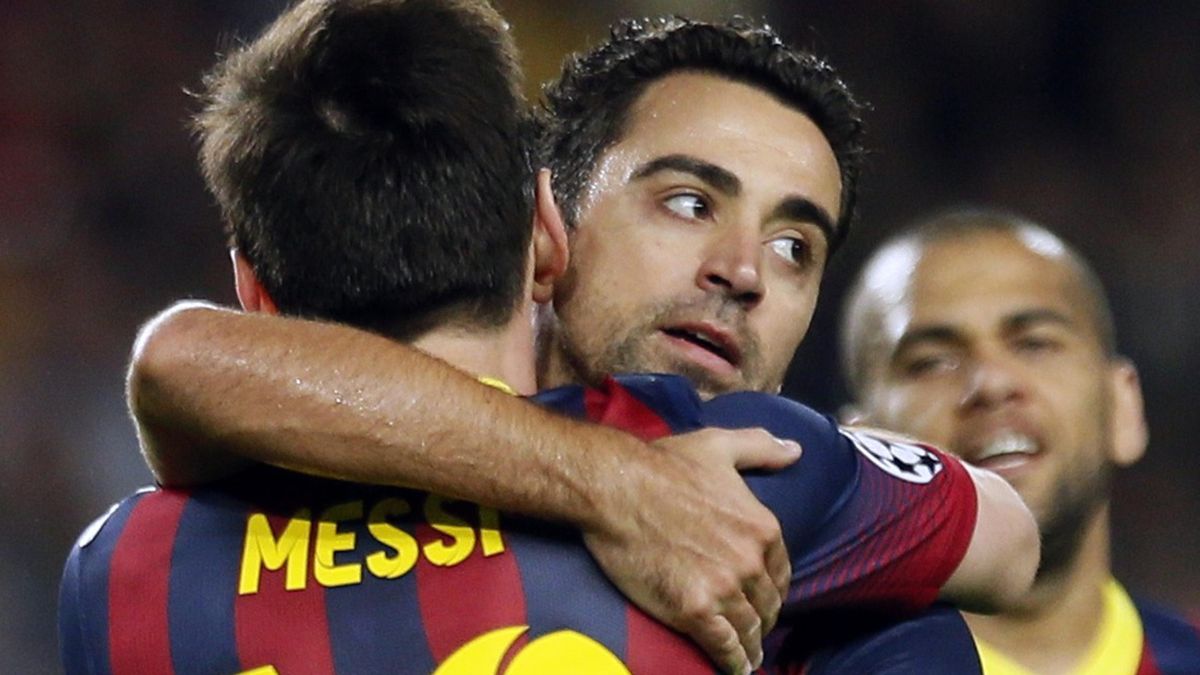 Xavi hugs Lionel Messi