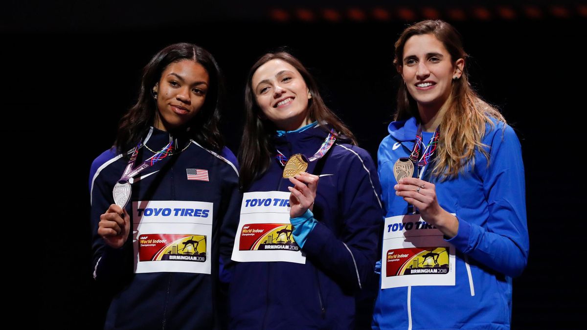 L-R) Silver medallist US athlete Vashti Cunningham, gold medallist Authorised Neutral Athlete Mariya Lasitskene and bronze medallist Italy's Alessia Trost pose on the podium during the medal ceremony for the women's high jump at the 2018 IAAF World Indoor