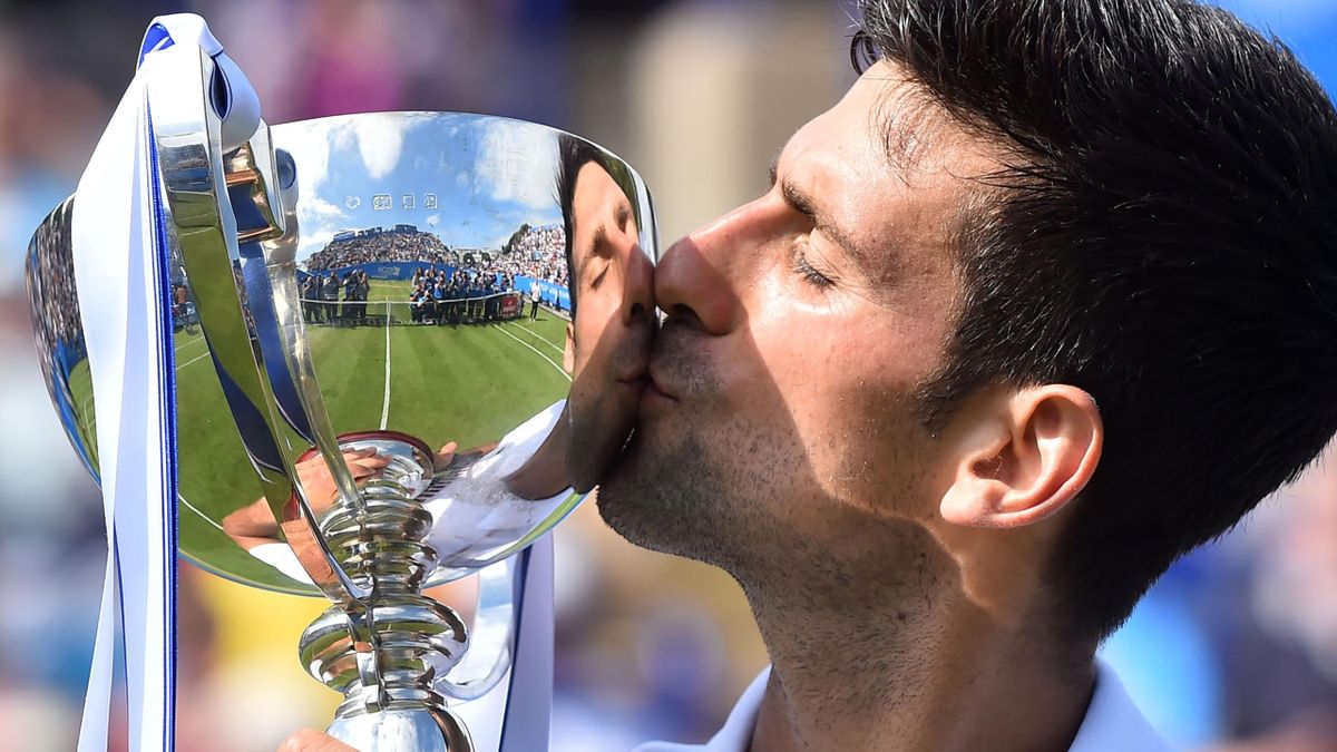 Serbia's Novak Djokovic poses with the trophy after victory over France's Gael Monfils during the men's final tennis match at the ATP Aegon International tennis tournament in Eastbourne, southern England, on July 1, 2017.