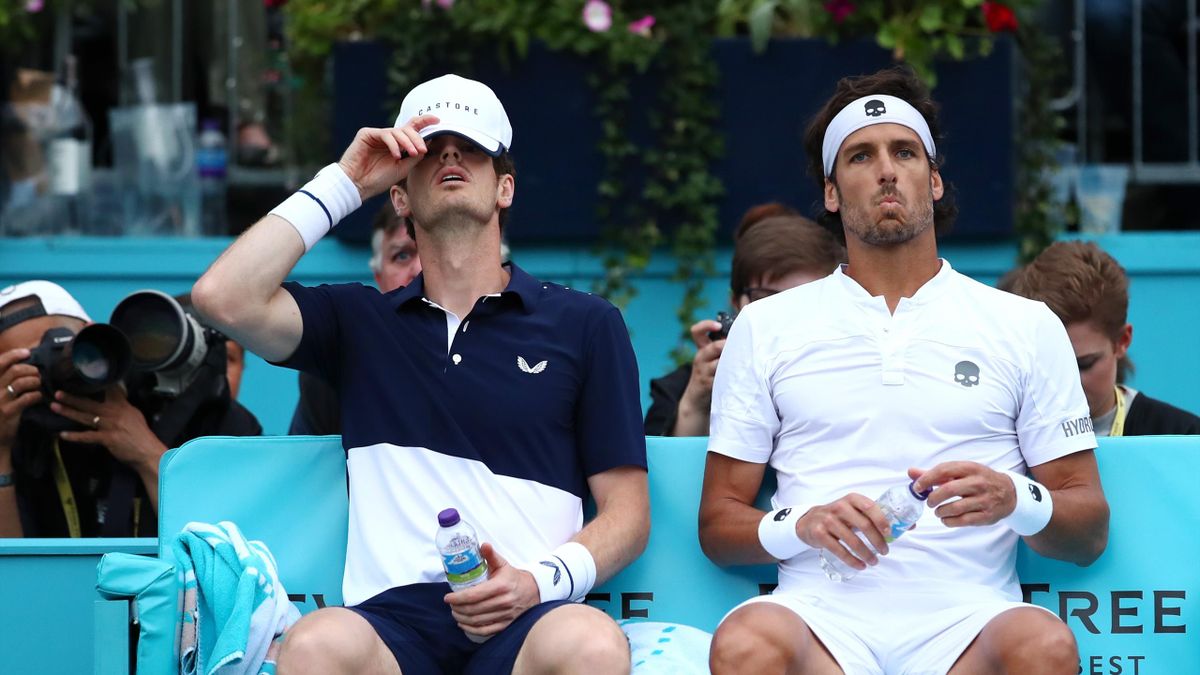 : Andy Murray of Great Britain and playing partner Feliciano Lopez of Spain look on as they sit down during a change of ends during their Quarter-Final Doubles Match against Daniel Evans and Ken Skupski of Great Britain during day Five of the Fever-Tree C