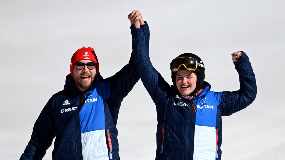 Millie Knight of Team Great Britain celebrates winning Bronze with her guide Brett Wild after the Women's Downhill Vision Impaired at Yanqing National Alpine Skiing Centre