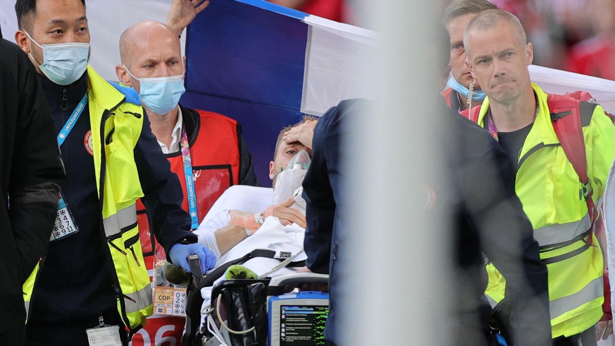 Denmark's midfielder Christian Eriksen (C) is evacuated after collapsing on the pitch during the UEFA EURO 2020 Group B football match between Denmark and Finland at the Parken Stadium