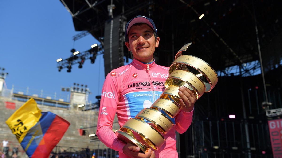 VERONA, ITALY - JUNE 02: Podium / Richard Carapaz of Ecuador and Movistar Team Pink Leader Jersey / Celebration / Trofeo Senza Fine / Trophy / Ecuadorian Flag / during the 102nd Giro d'Italia 2019, Stage 21 a 17km Individual Time Trial stage from Verona -