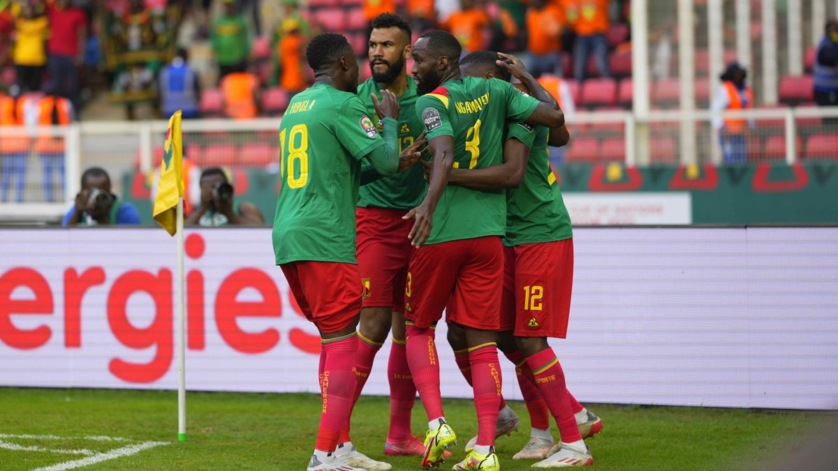 Karl Toto Ekambi is congratulated by his teammates following his first goal of the game