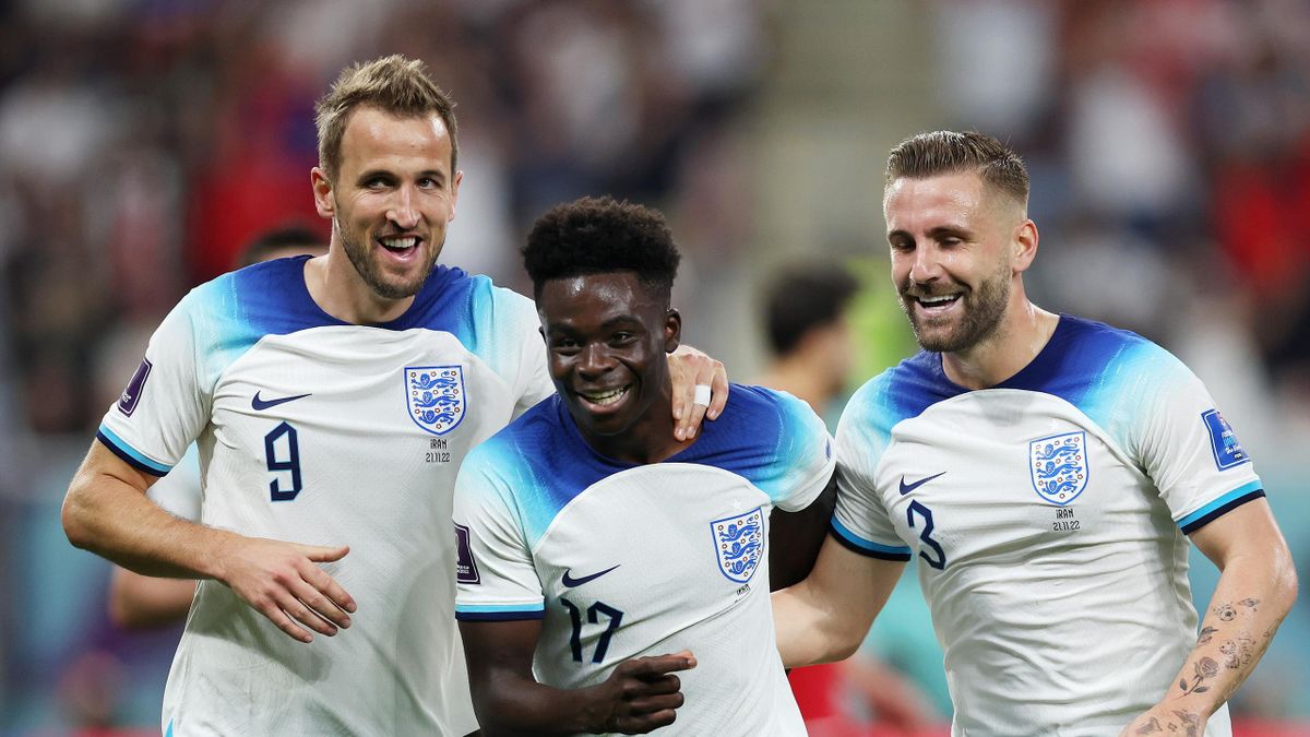 Bukayo Saka of England celebrates with teammates Harry Kane and Luke Shaw after scoring their team's fourth goal during the FIFA World Cup Qatar 2022 Group B match between England and IR Iran