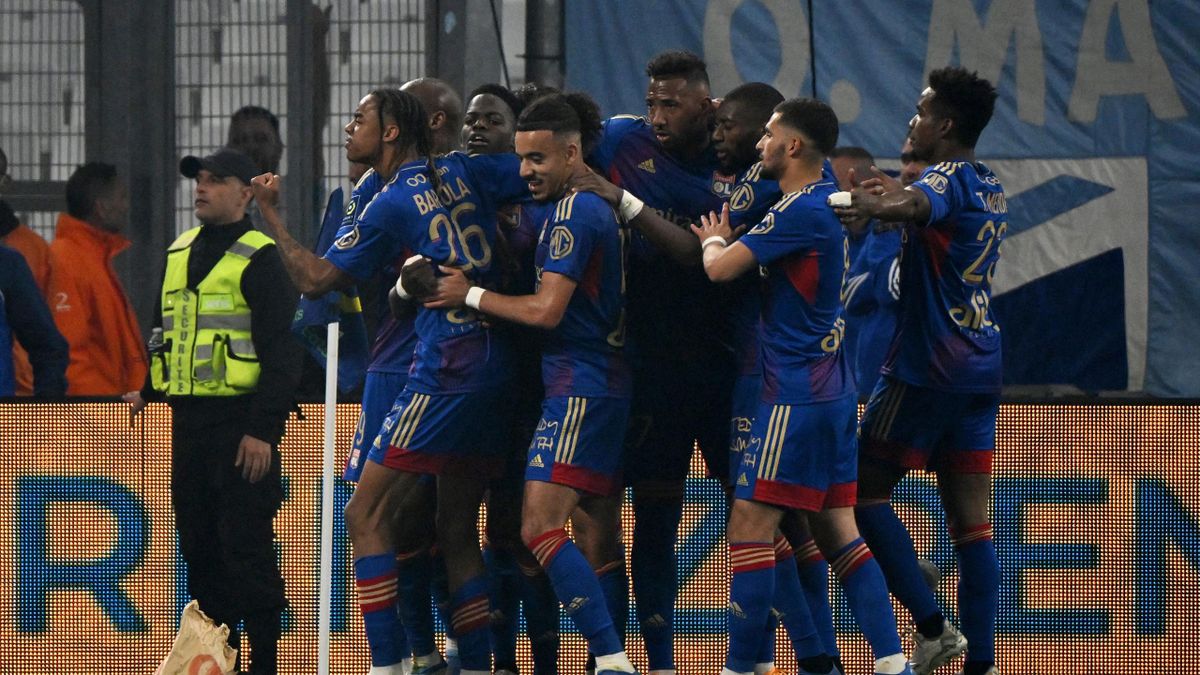 Lyon's players celebrate after scoring their first goal during the French L1 football match between Olympique Marseille (OM) and Olympique Lyonnais at Stade Velodrome in Marseille, southern France, on May 1, 2022