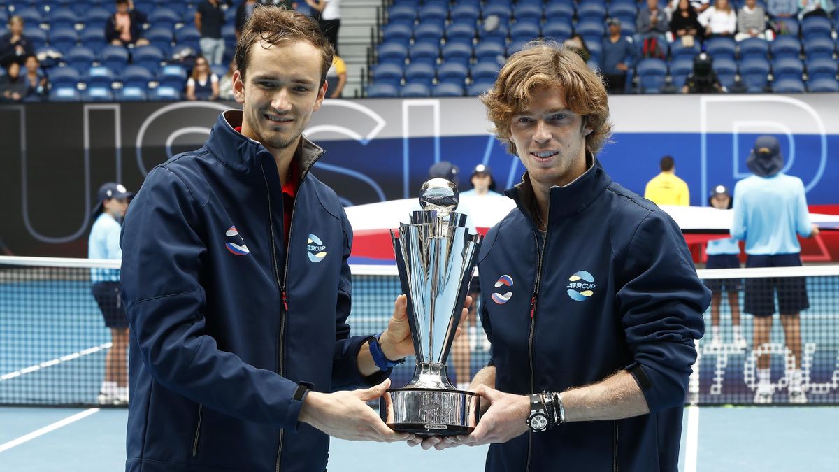 Daniil Medvedev of Russia and Andrey Rublev of Russia pose with the ATP Cup Trophy after defeating Italy in the Final during day six of the 2021 ATP Cup at Rod Laver Arena