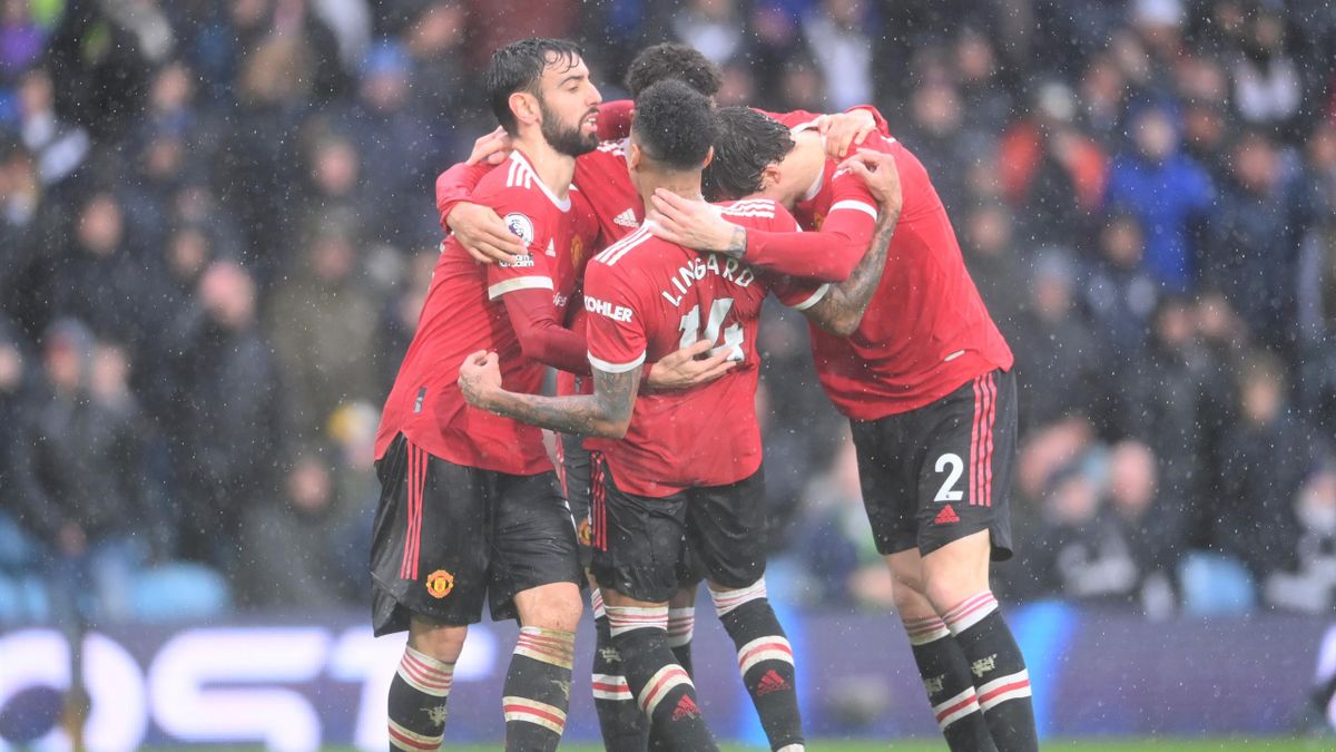 Bruno Fernandes celebrates with team-mates Jesse Lingard and Victor Lindelof of Manchester United after scoring during the Premier League match between Leeds United and Manchester United at Elland Road on February 20, 2022