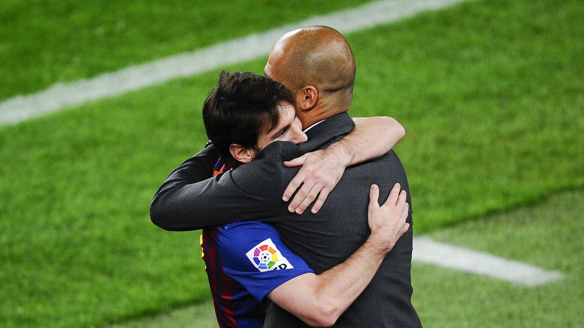 Lionel Messi of FC Barcelona (R) hugs his Head coach Josep Guardiola of FC Barcelona